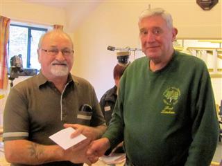 Bert presents Alan with a voucher for his work through the year